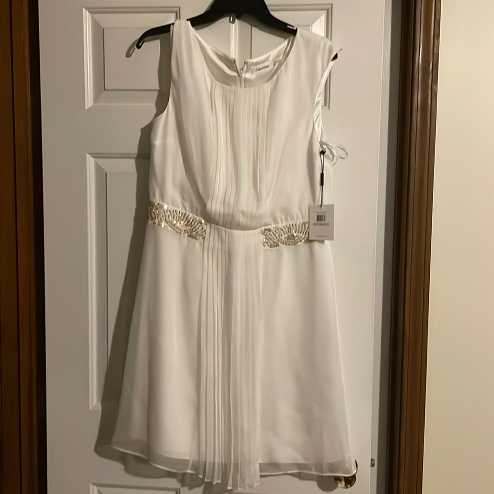 White Calvin Klein dress with gold embellishments